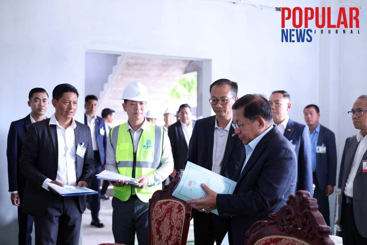 Engineers reviewing blueprints on site